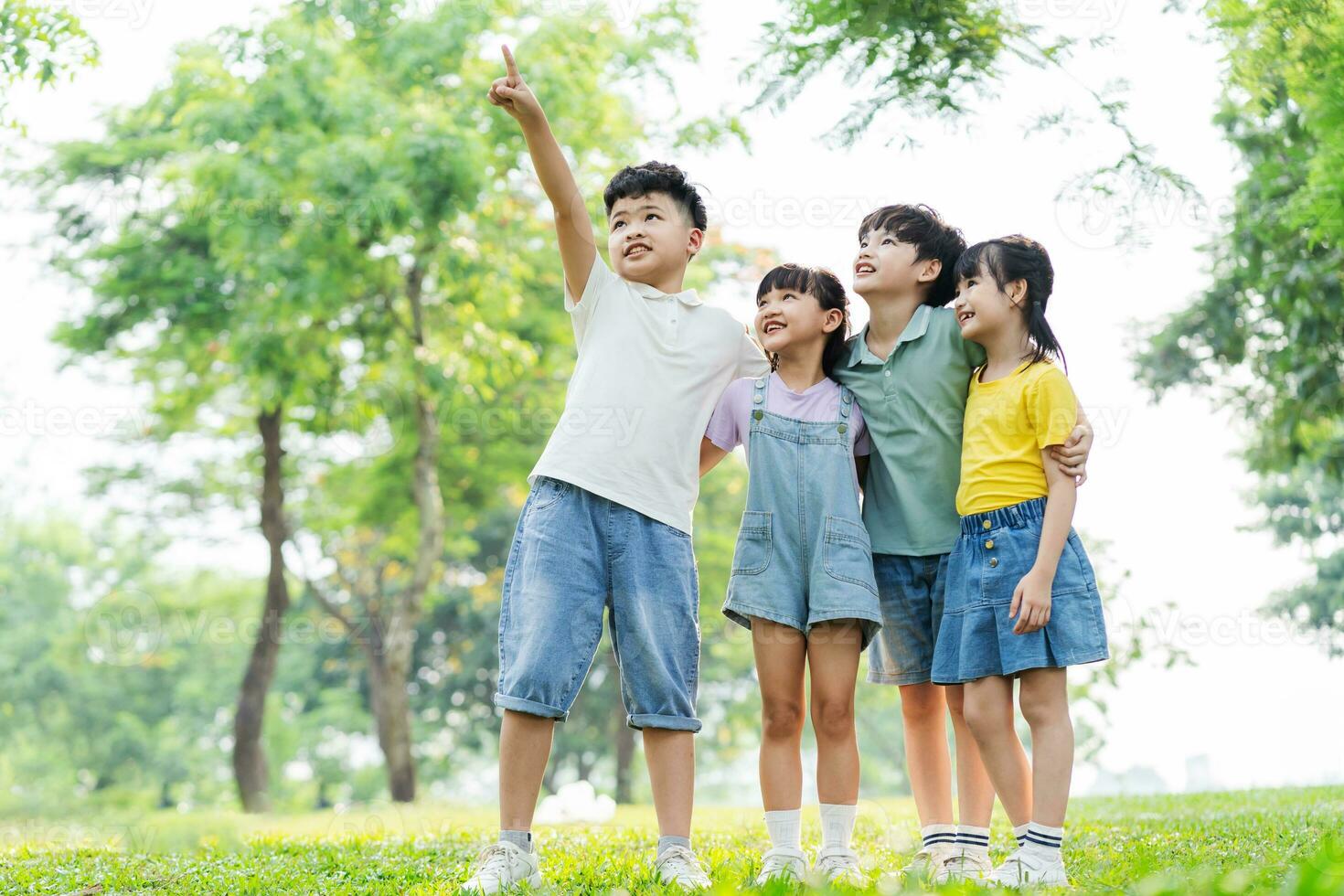 group of cute asian kids having fun in the park photo