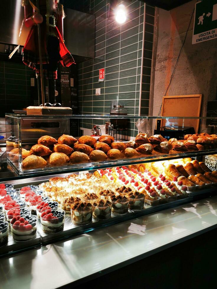 Bakery shop window with assortment of fresh pastries and croissants photo