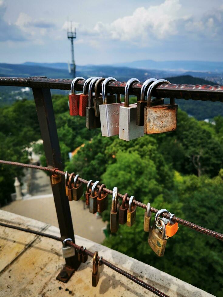 Love locks in changing colors on Janos Hill, Budapest photo