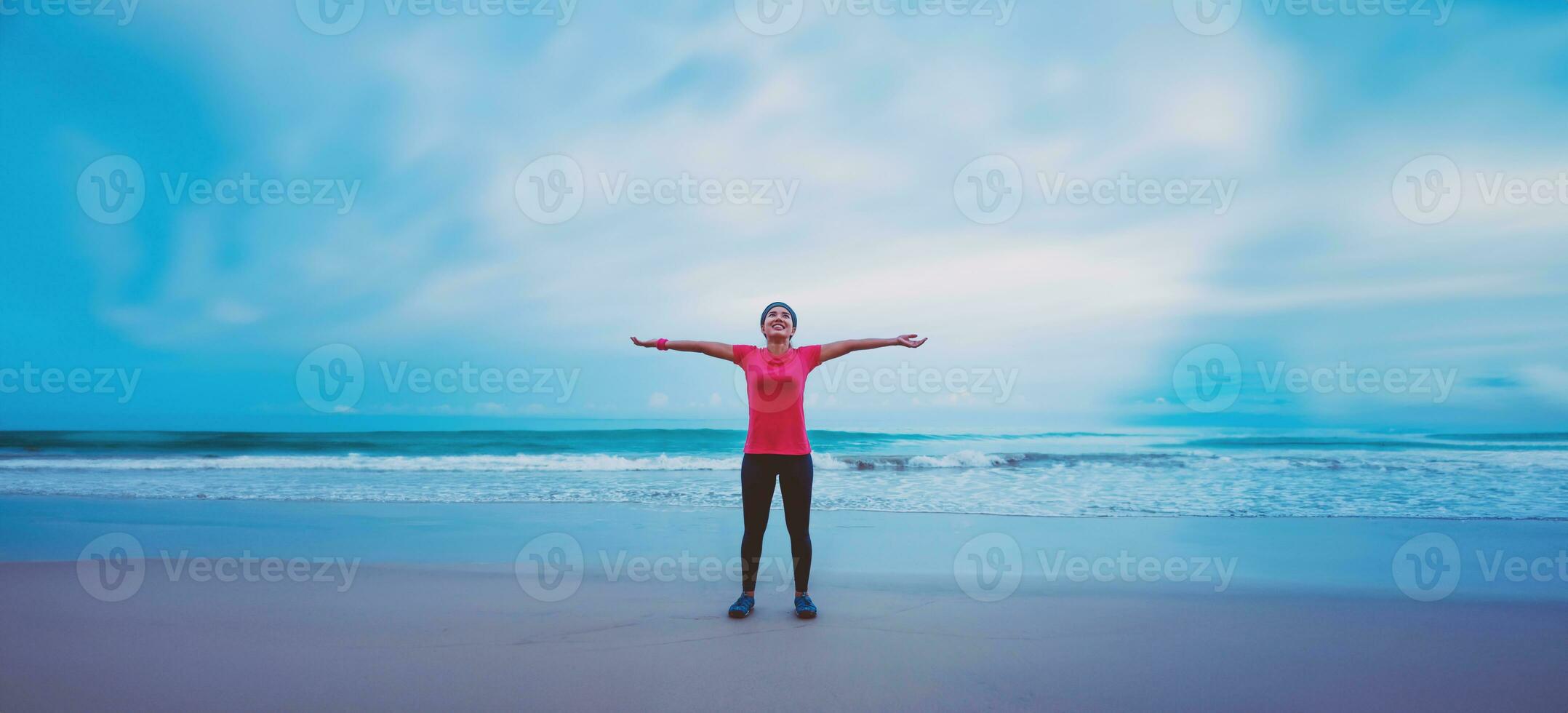 Asian women running workout jogging on the beach in the morning. extend the arms relax. photo