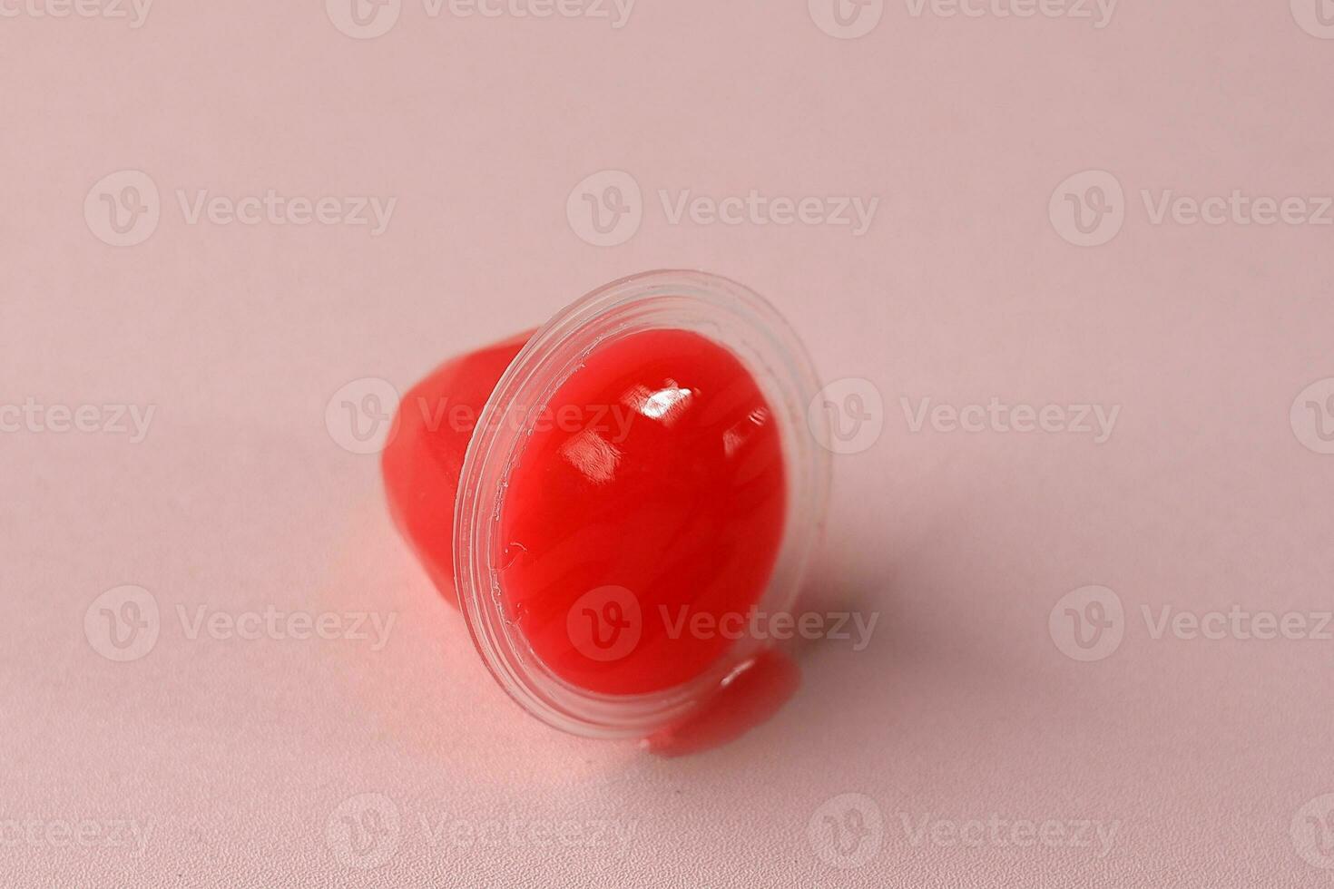 Red Jelly Cup on Pink Background photo