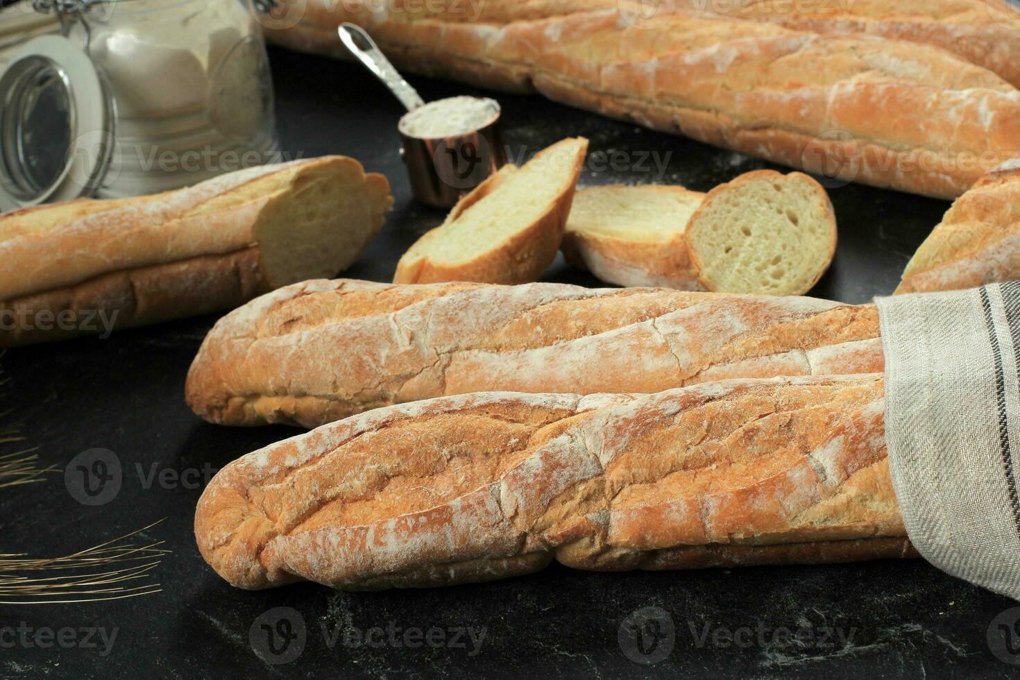 Fresh French Baguettes on Dark Background. photo