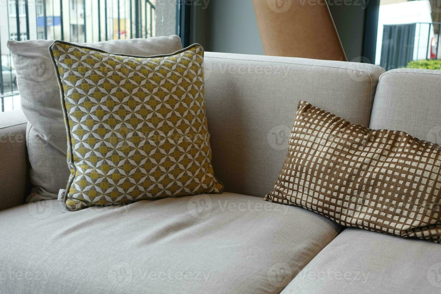 modern grey sofa with pillows in living room at home photo