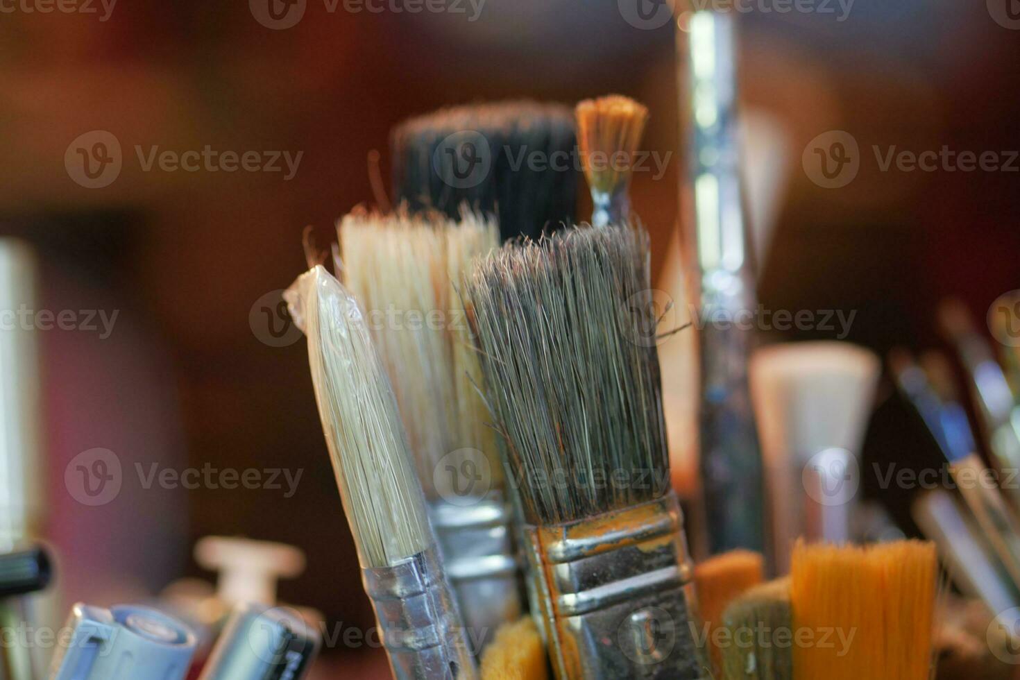 Paints and paint brushes in an artists studio. photo