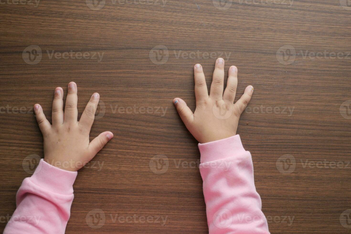 top view of baby hand on table photo