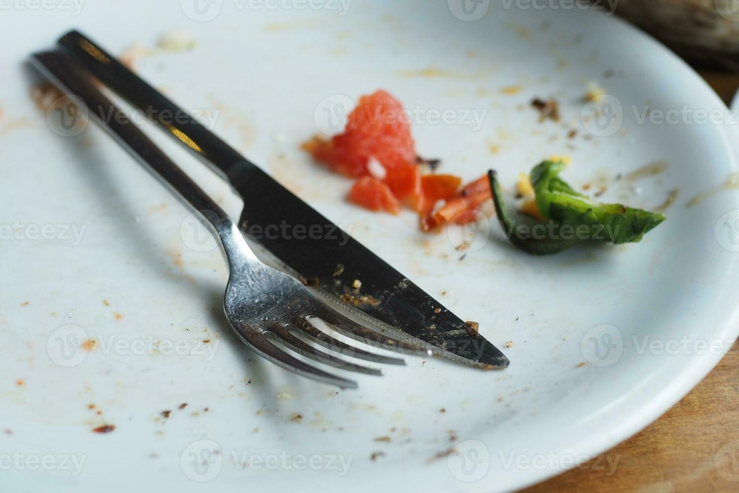 Empty plate after eating on table photo