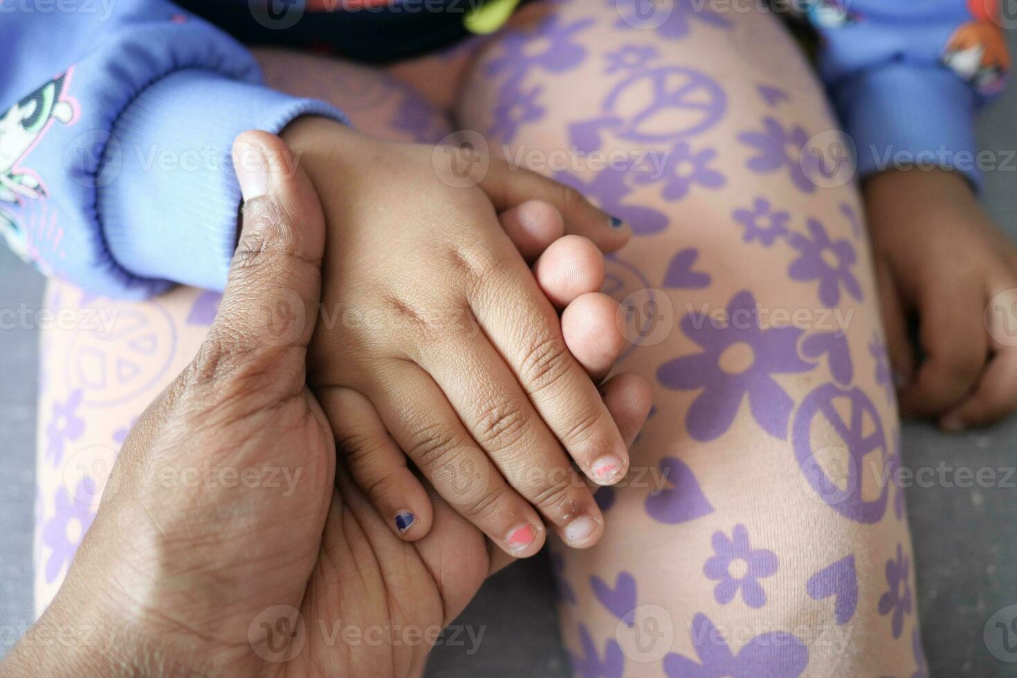 father holding hand of baby child, close up . photo