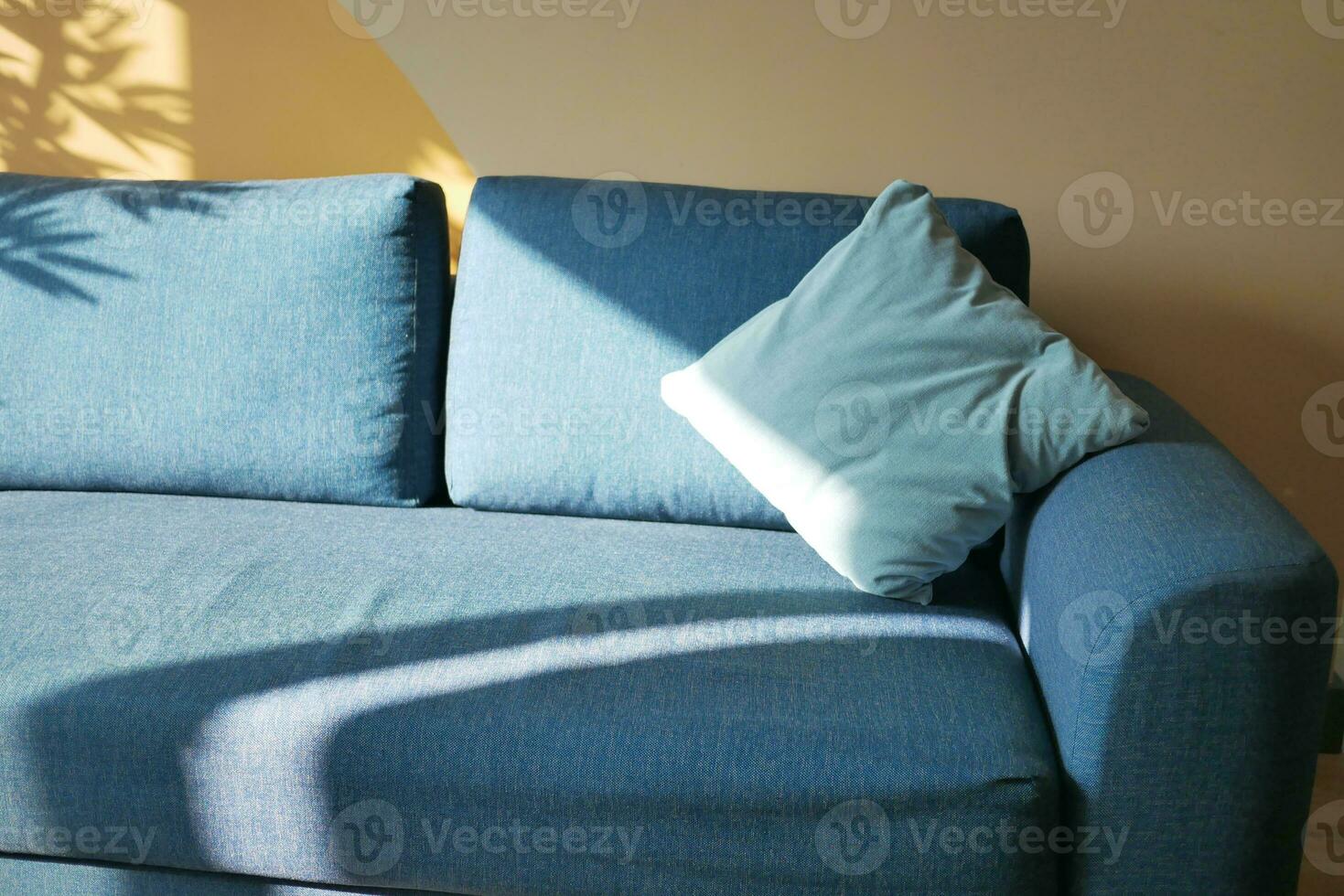modern grey sofa with pillows in living room at home photo