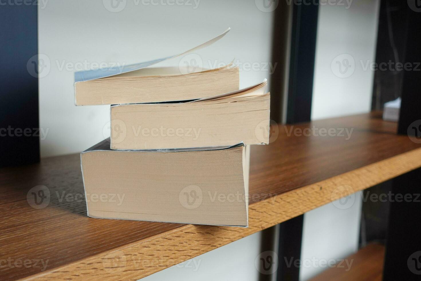 stack of books in a book shelf photo