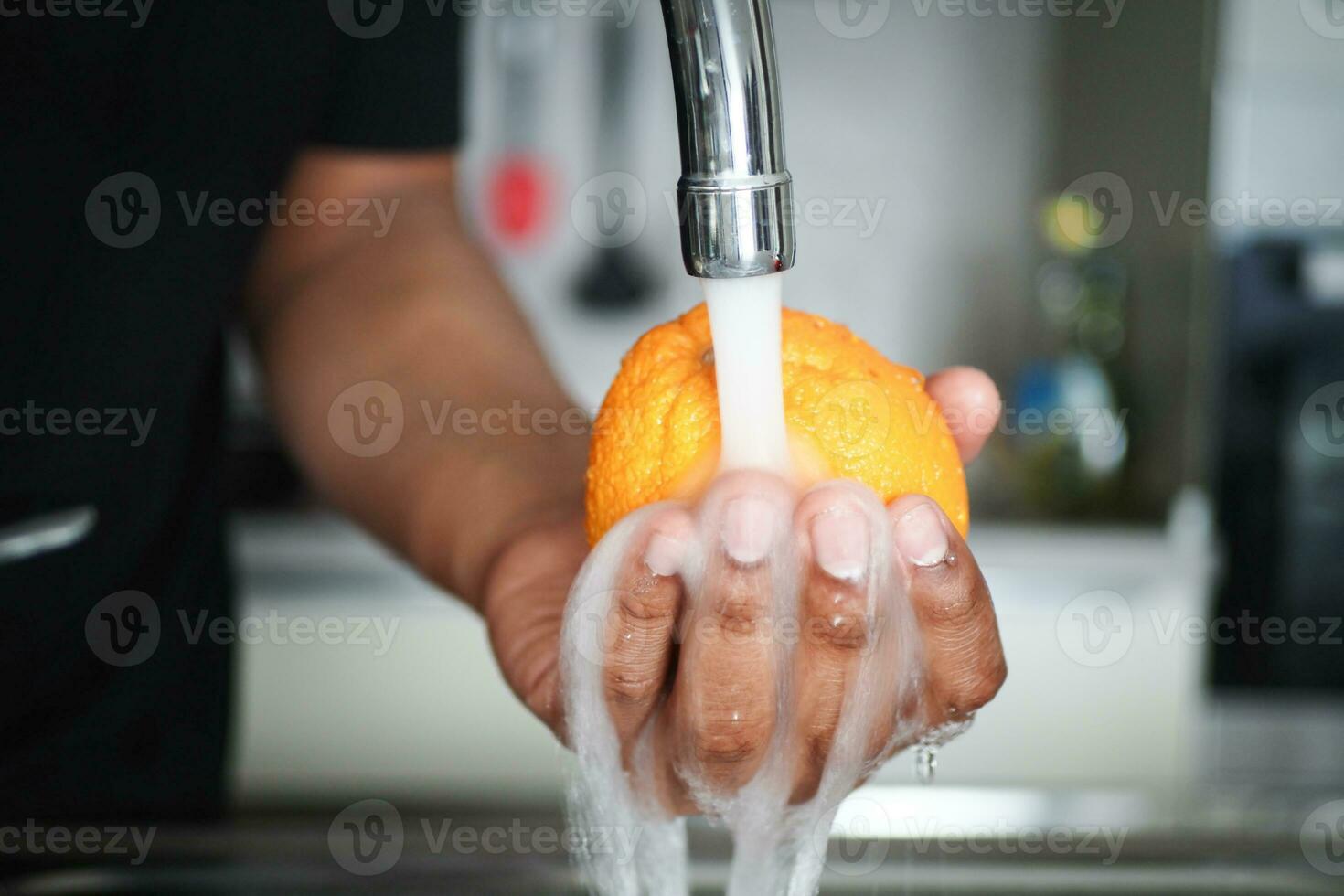 Orange with splash of water closeup photo