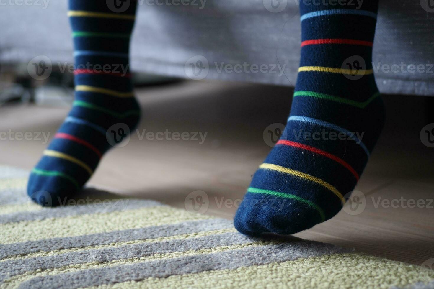 a colorful soft socks on child feet . photo