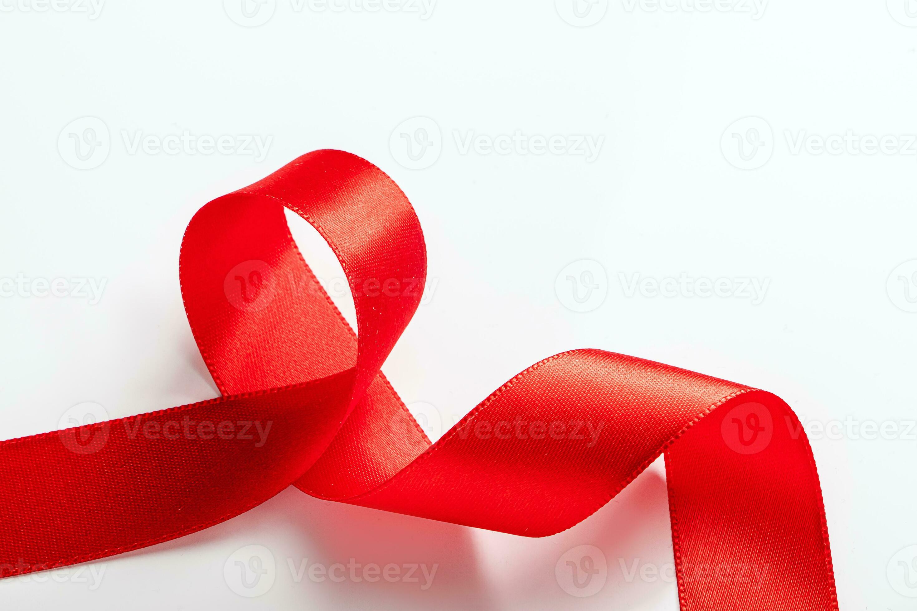 Red silk ribbon for wrapping gifts on white background. 26712895