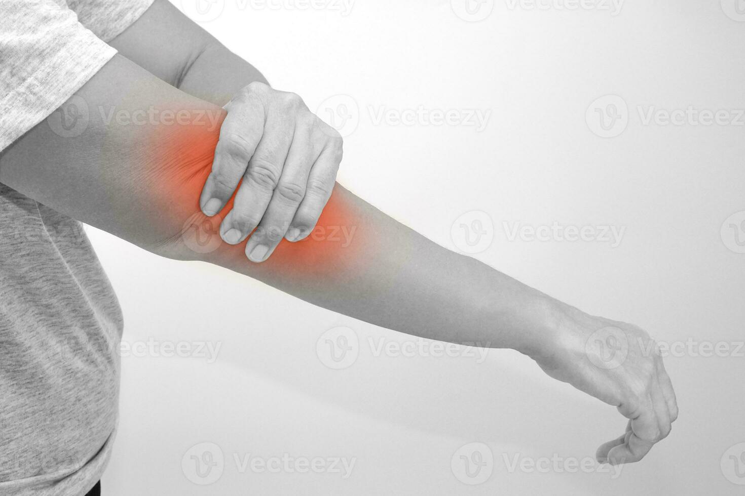 Black and white photo of woman suffering from elbow pain. Healthcare and office syndrome concept.