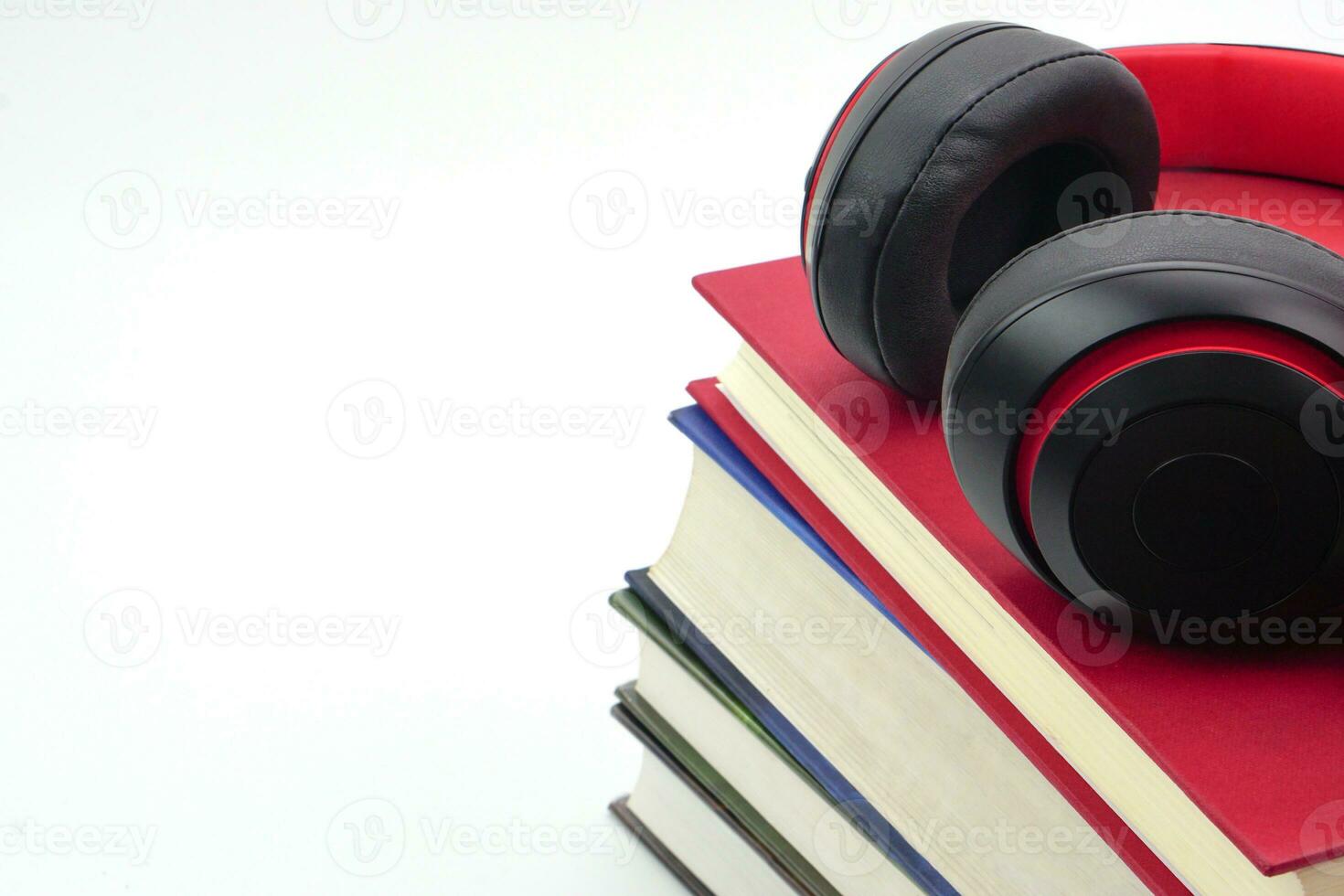 The headphones are on stack of books. Modern education and relaxation concept. photo