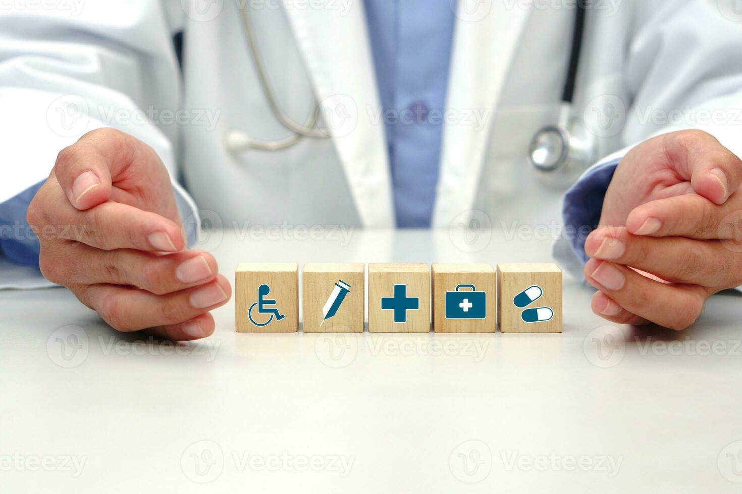 Hand of doctor protecting to healthcare medical icon symbol on wooden block cube for health insurance and medical concept. photo