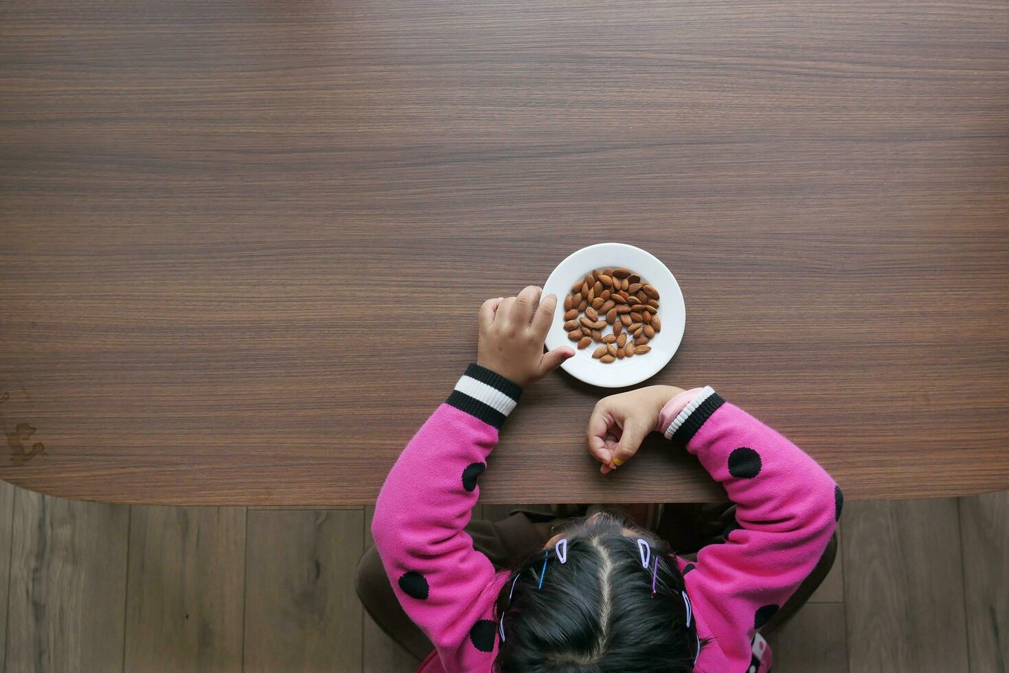 top view of child hand pick almond nut photo