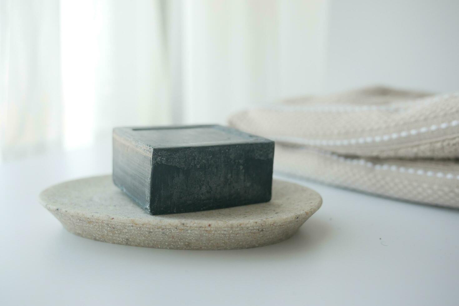 natural soap bar and towel on white background photo