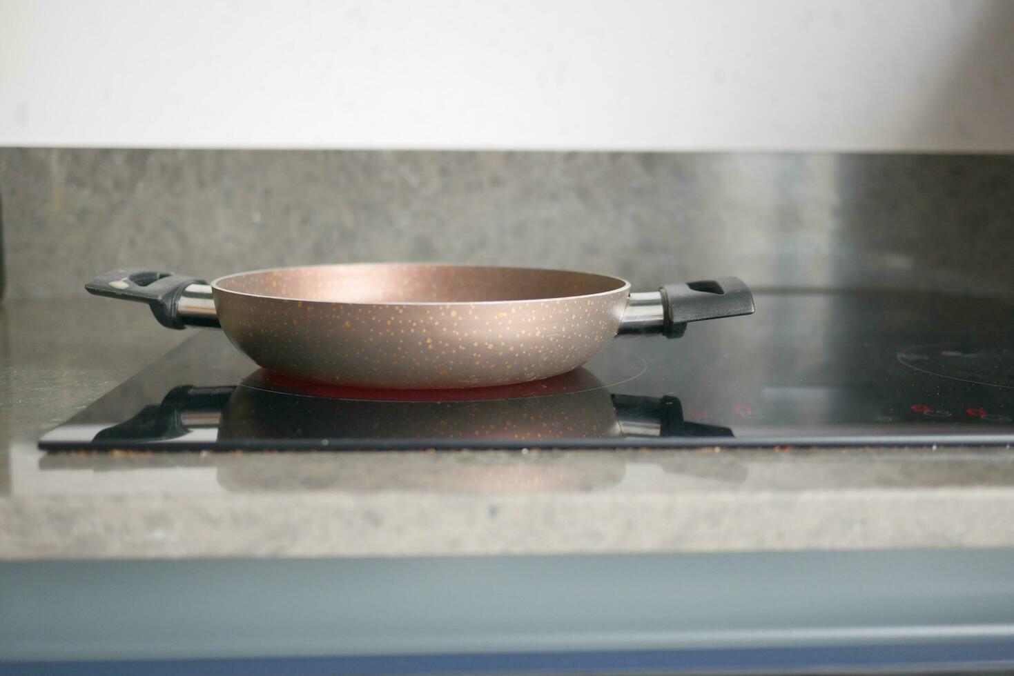 cooking pan on electric stove, electric stove is heated to red. photo