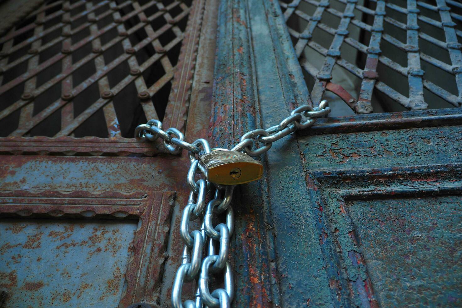 Closed old rusty lock on a wooden door photo