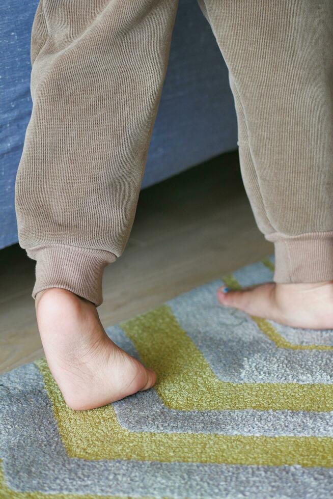 low angle view of A child walking on tiptoes photo