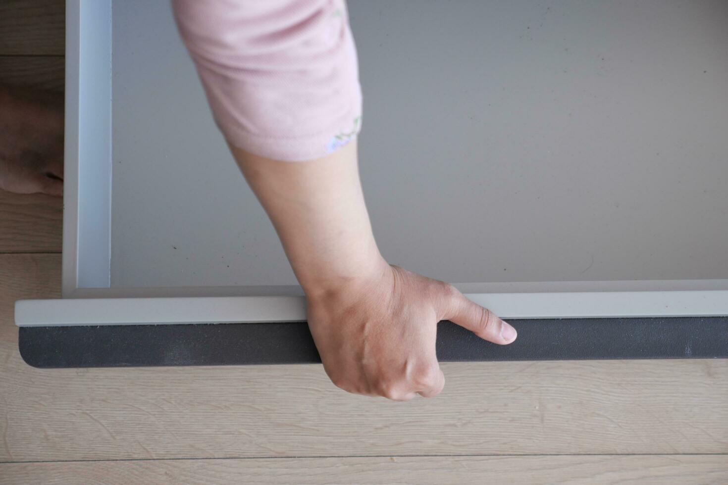 hand open drawer wooden in cabinet photo