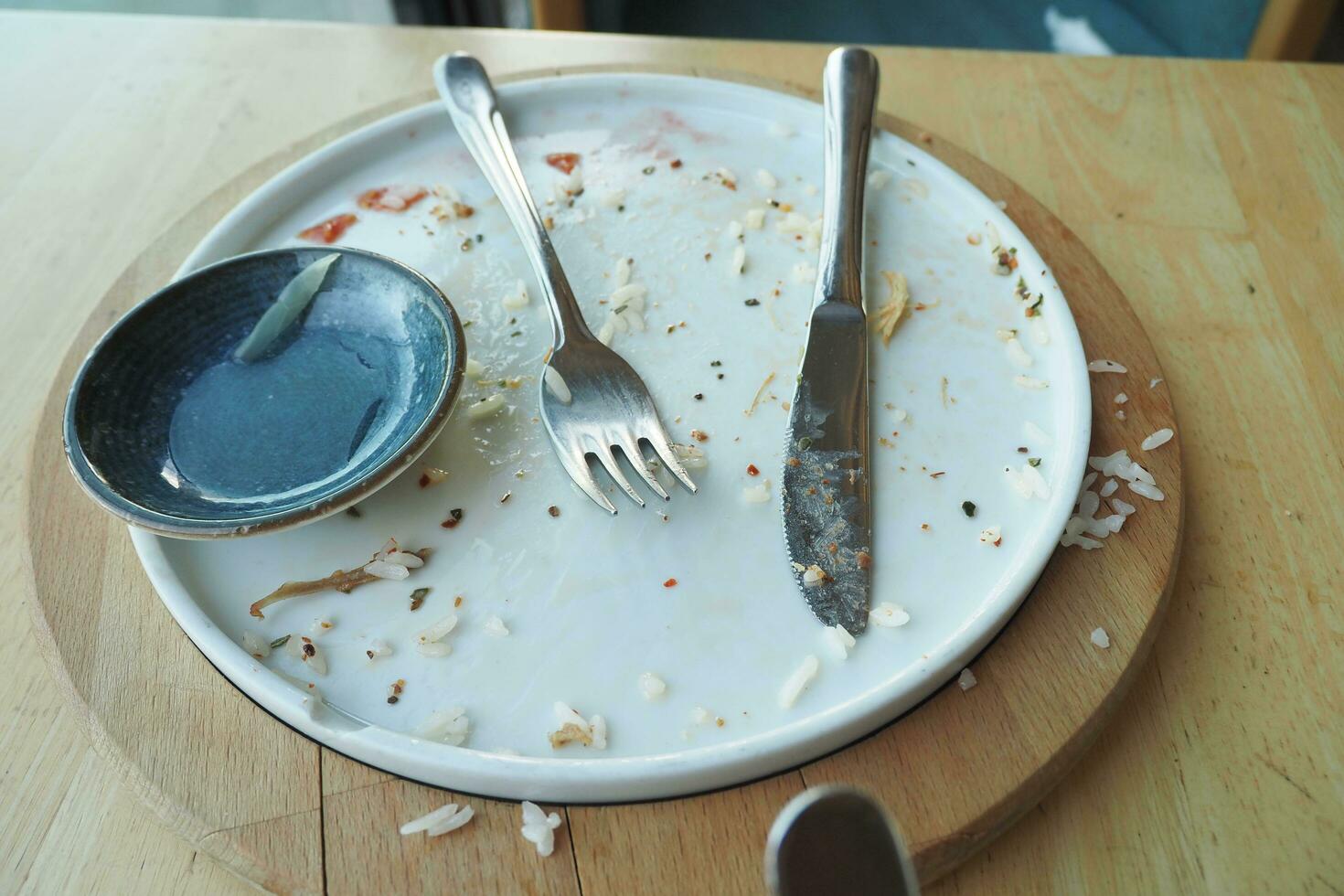 Empty plate after eating on table photo