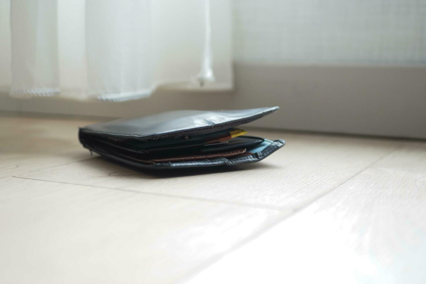 left wallet on floor at home photo