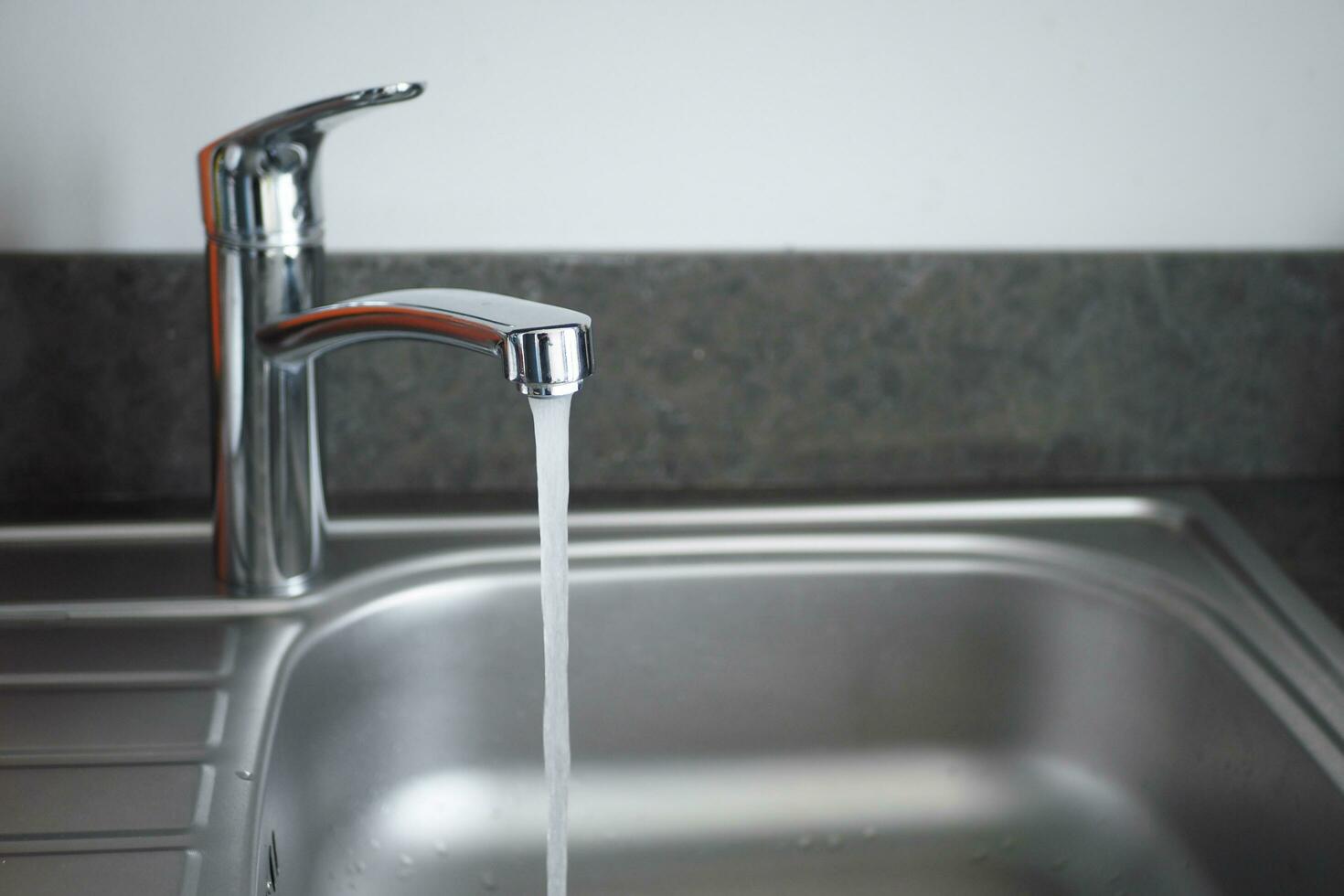 water pouring from a faucet tap slow motion photo