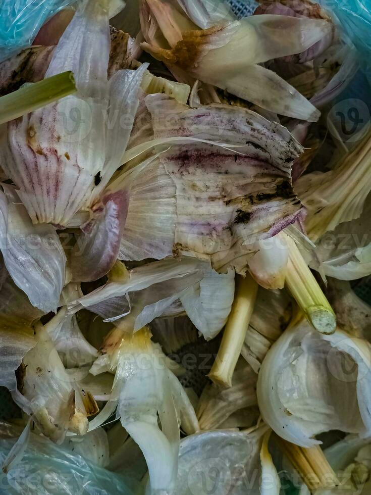 Organic waste after peeling garlic. Background of waste from vegetable crops. photo