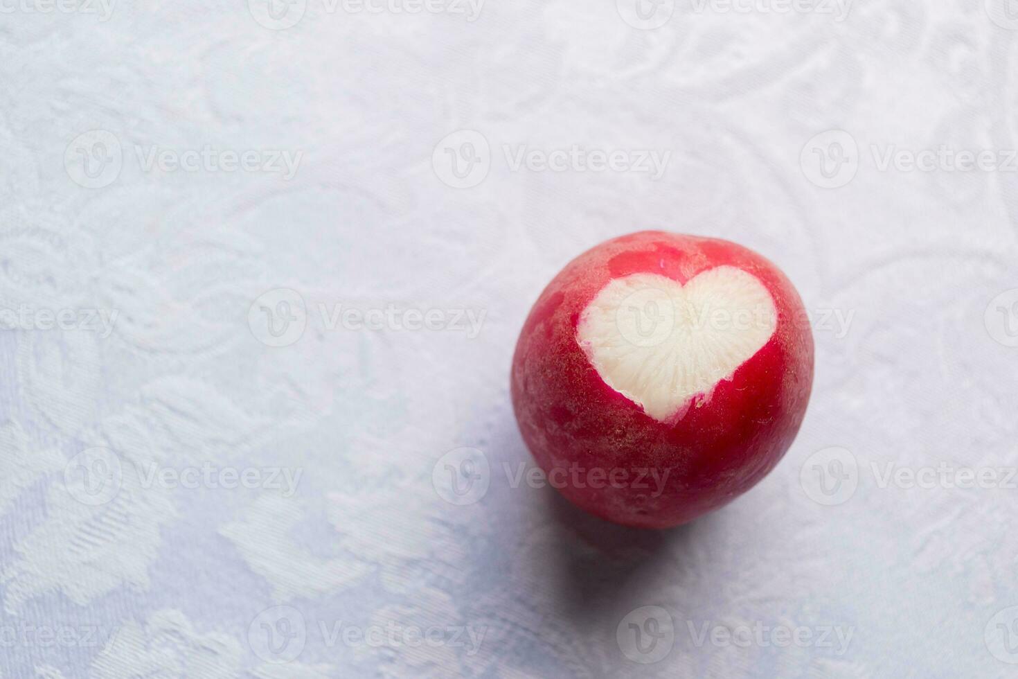 heart-shaped radishes on a white textured tablecloth photo