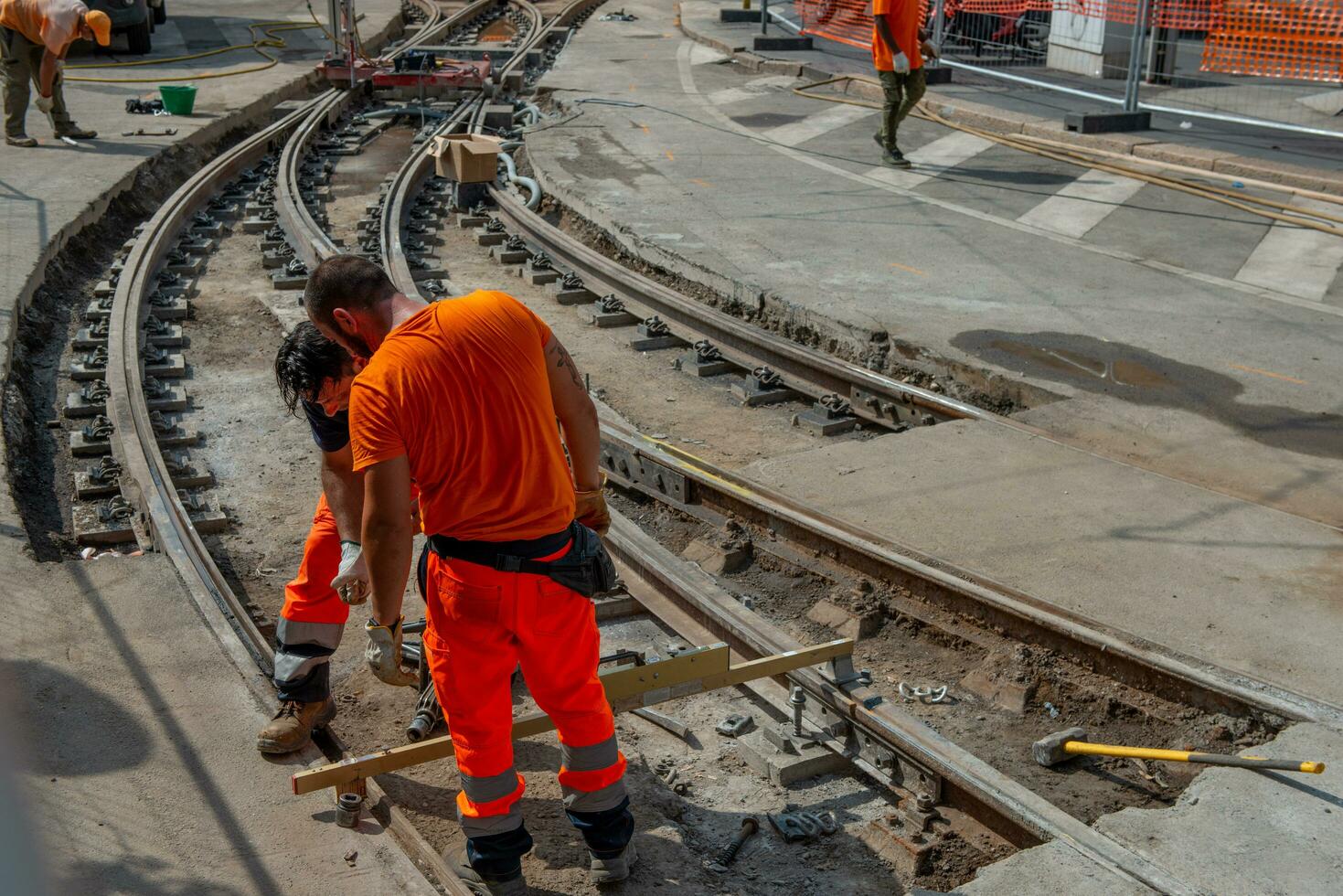 Workers at work while sistenabo the tram rails photo