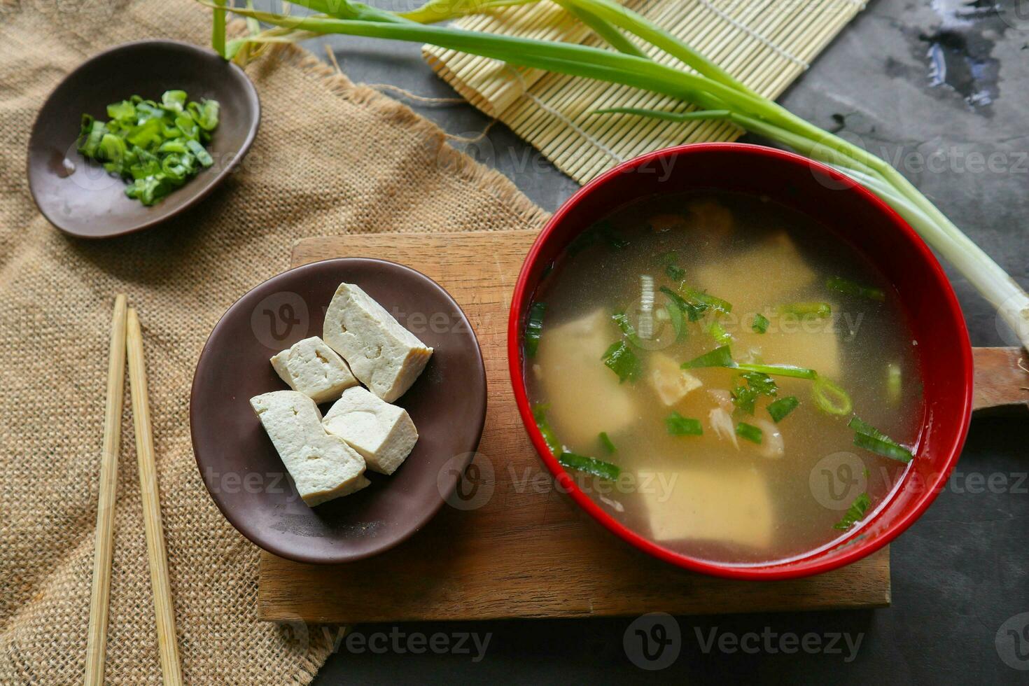 miso soup or Japanese miso soup in bowl on the table. Japanese cuisine in the form of soup with dashi ingredients, tofu, seafood, vegetables, and topped with miso to taste photo