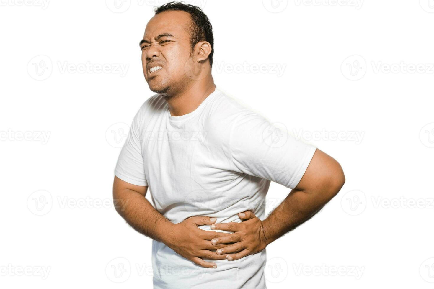 Photo of young unwell sick ill man with tshirt hold hand on stomach suffers pain isolated on white background