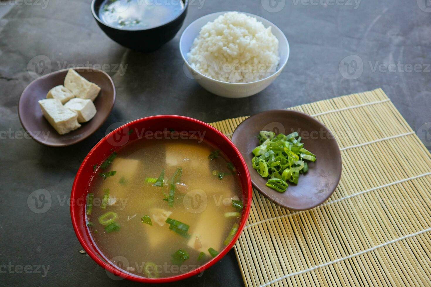 miso soup or Japanese miso soup in bowl on the table. Japanese cuisine in the form of soup with dashi ingredients, tofu, seafood, vegetables, and topped with miso to taste photo