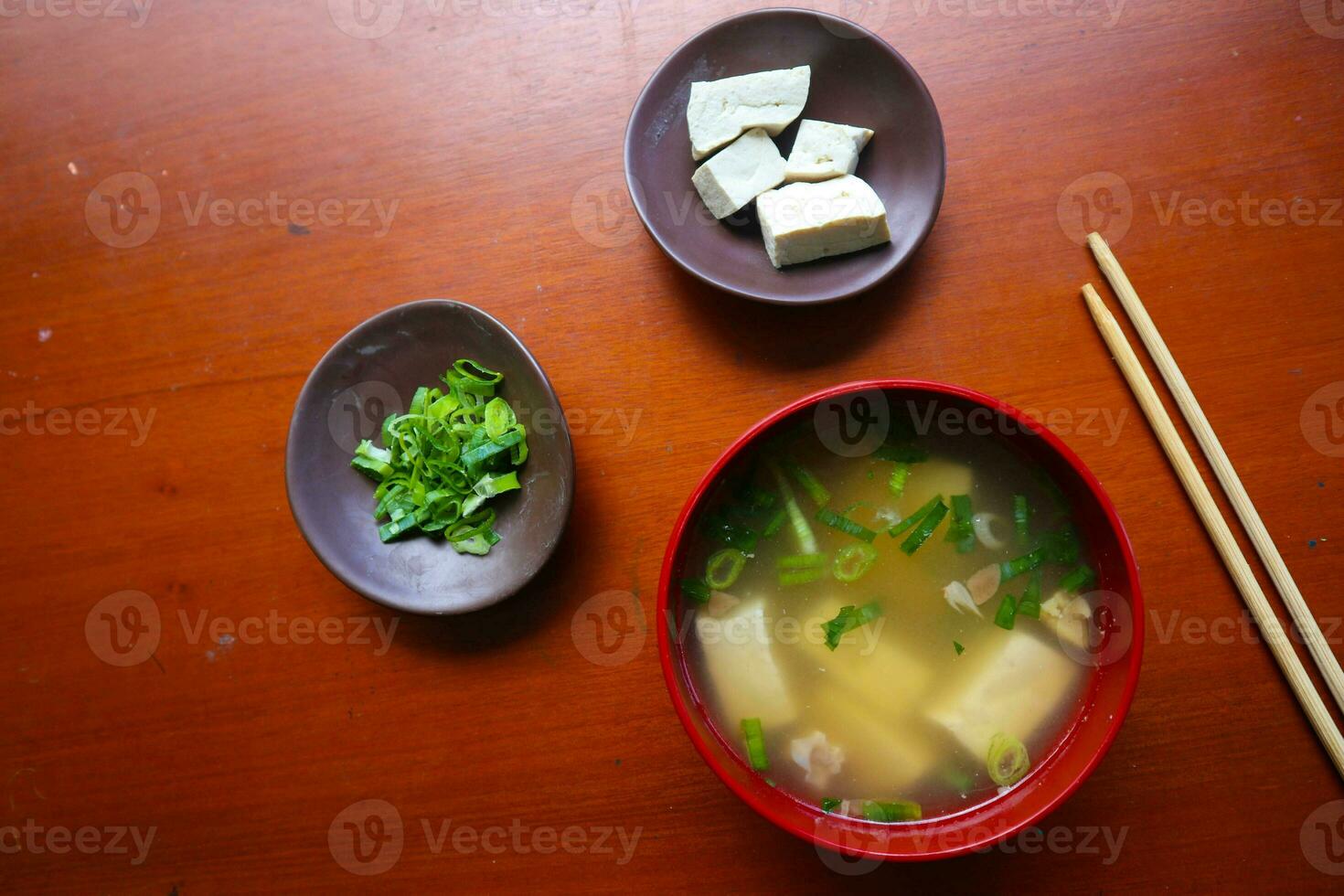 miso soup or Japanese miso soup in bowl on the table. Japanese cuisine in the form of soup with dashi ingredients, tofu, seafood, vegetables, and topped with miso to taste photo