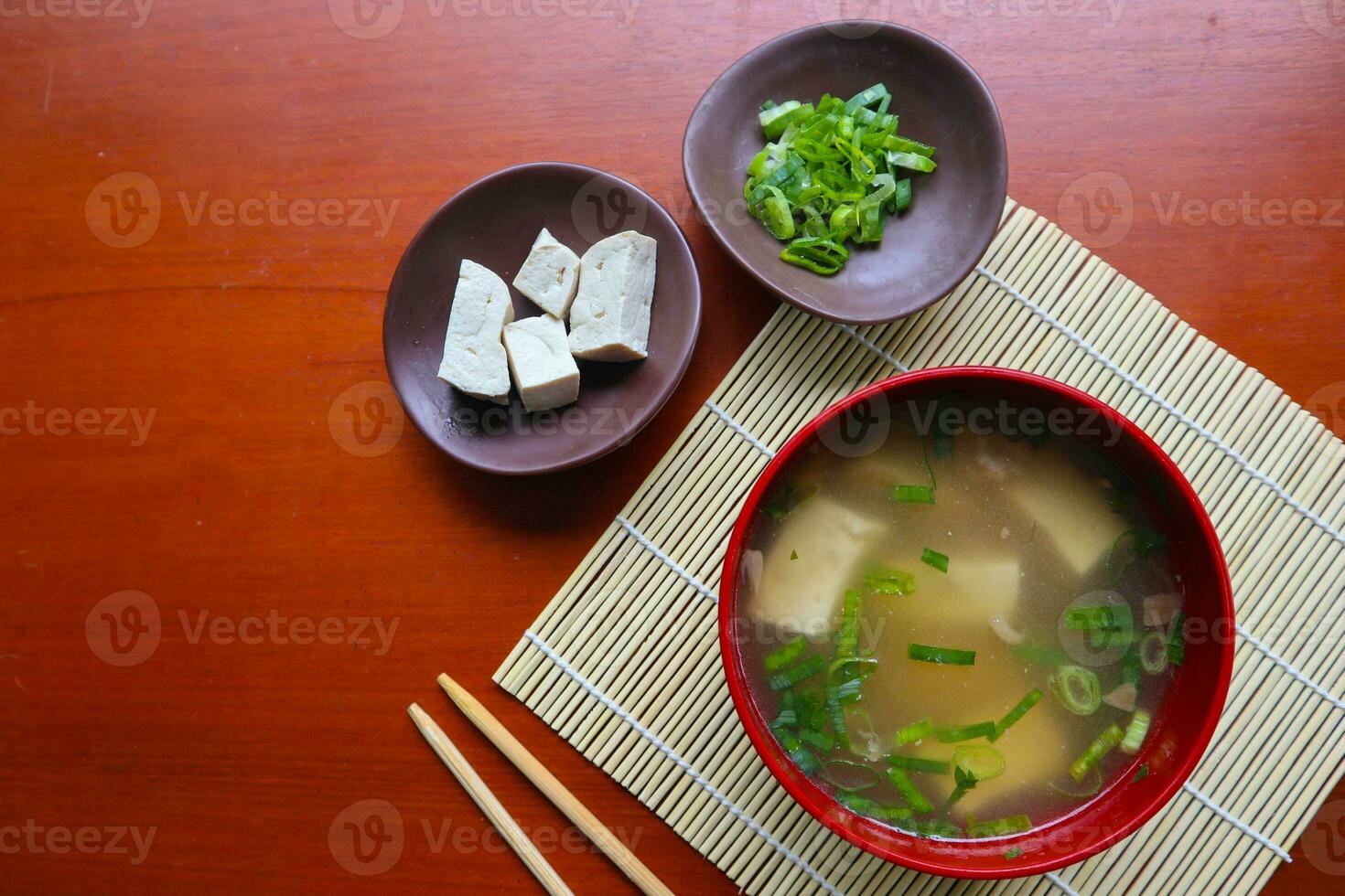 miso soup or Japanese miso soup in bowl on the table. Japanese cuisine in the form of soup with dashi ingredients, tofu, seafood, vegetables, and topped with miso to taste photo