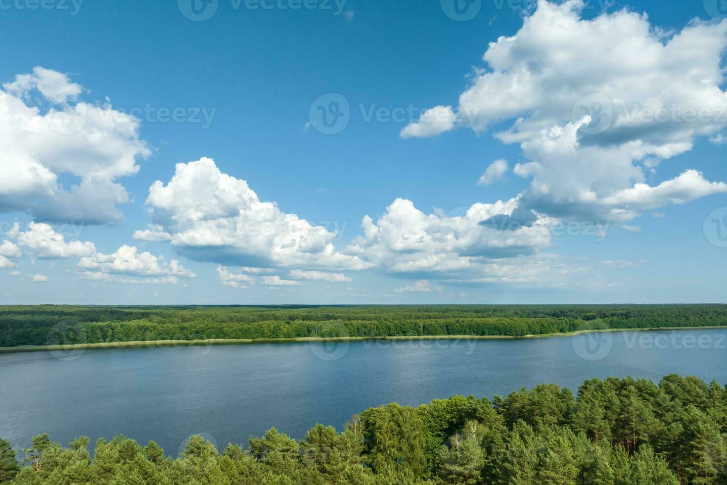 panorama aerial view over lake among forest photo