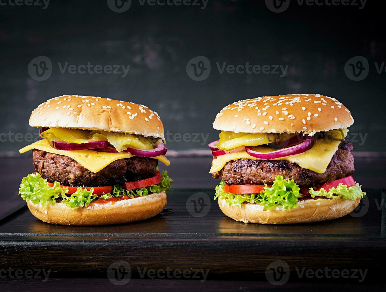 Big sandwich - hamburger burger with beef,  tomato, cheese, pickled cucumber and red onion. photo