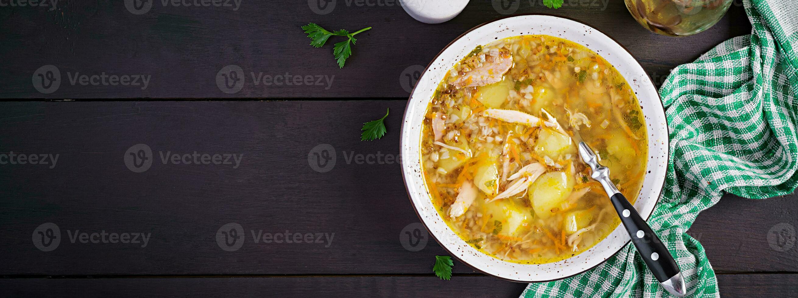 Chicken soup with potatoes and buckwheat. Top view, banner photo