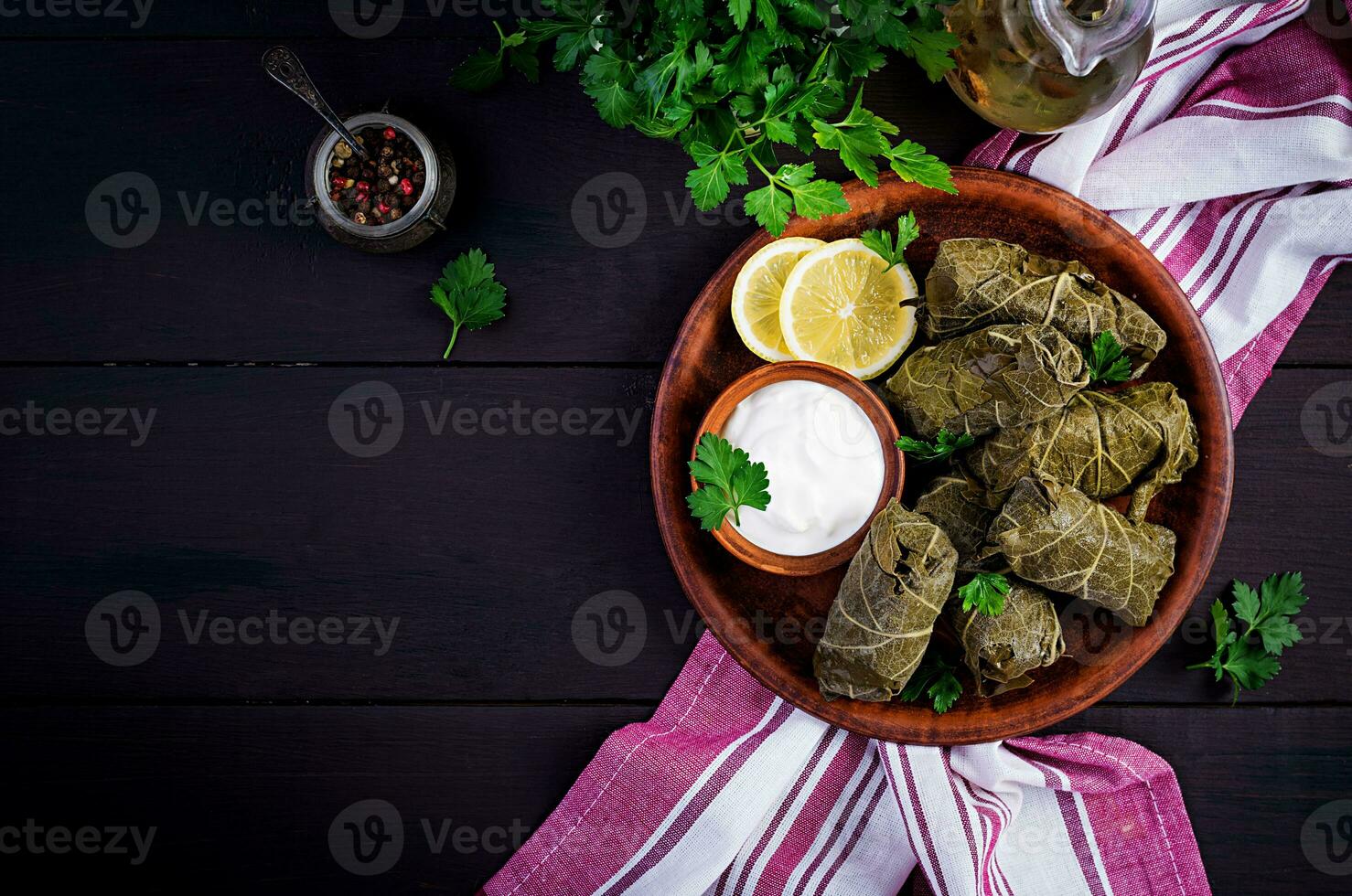 Dolma. Stuffed grape leaves with rice and meat on dark table. Middle eastern cuisine. Top view, overhead, copy space photo