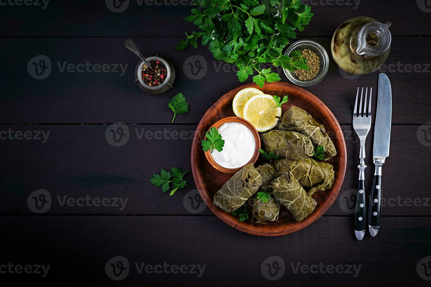 Dolma. Stuffed grape leaves with rice and meat on dark table. Middle eastern cuisine. Top view, overhead, copy space photo