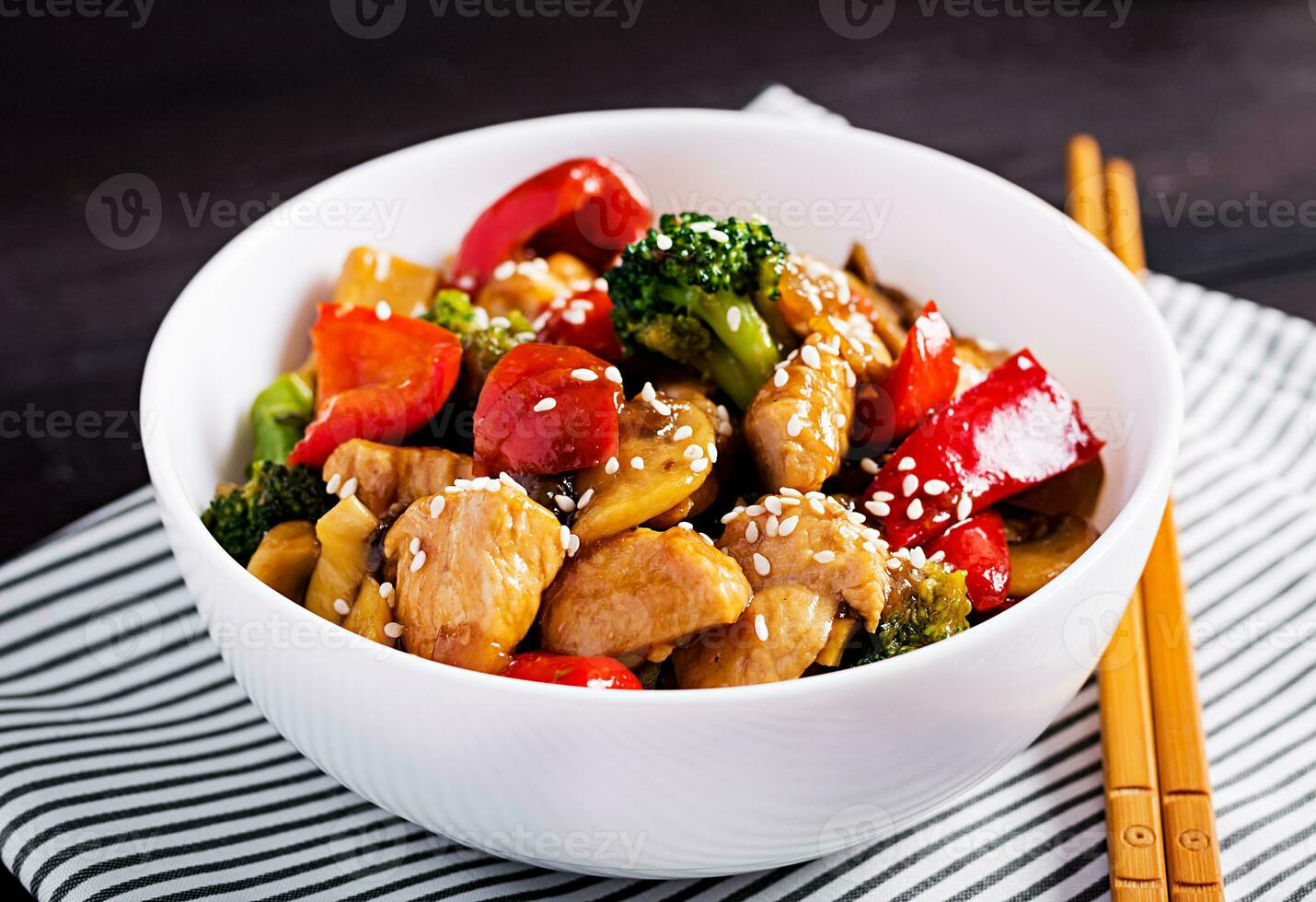 Stir fry with chicken, mushrooms, broccoli and peppers. Chinese food. photo