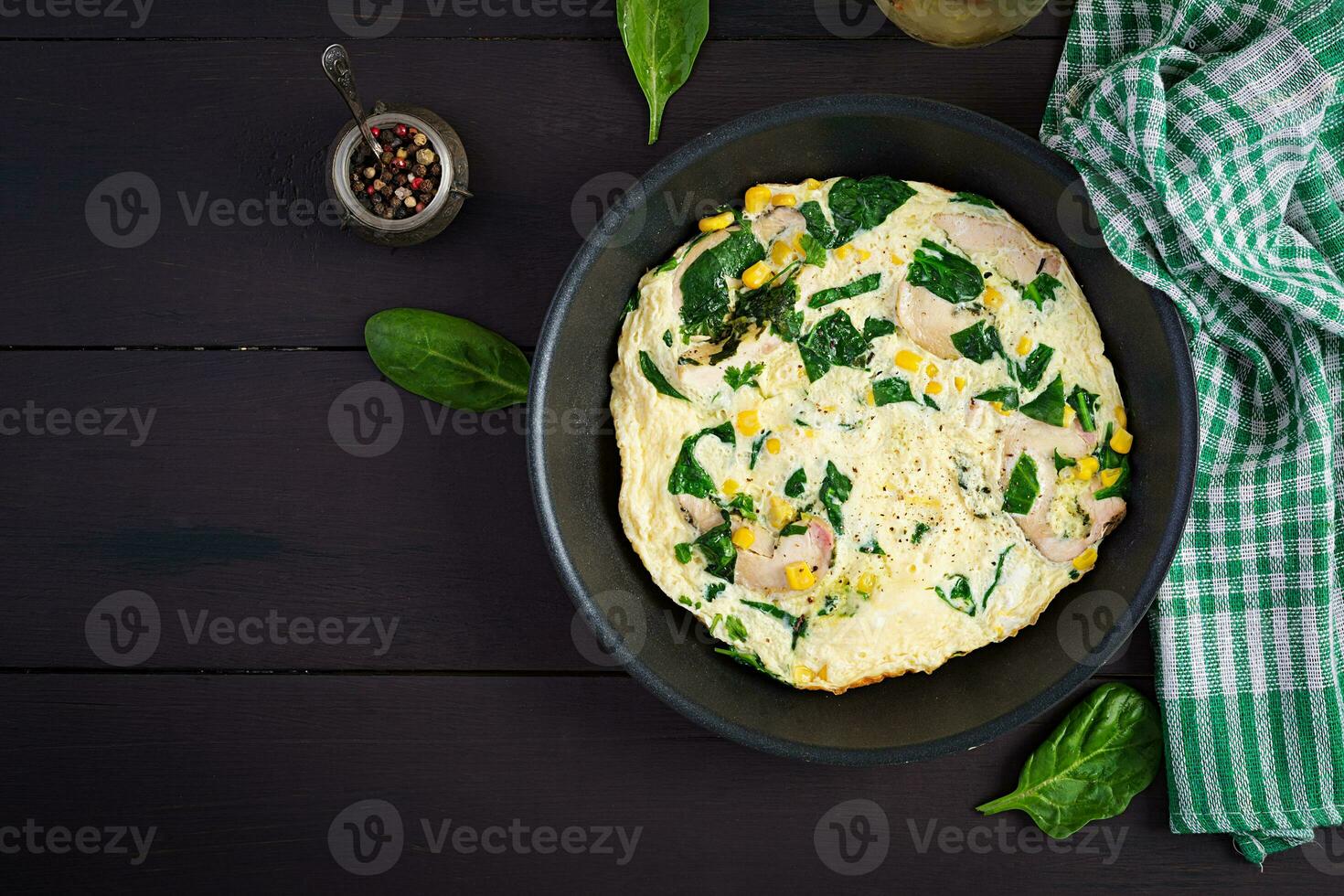 Protein omelet with chicken roll, spinach and corn. Frittata. Keto, paleo diet. Top view photo