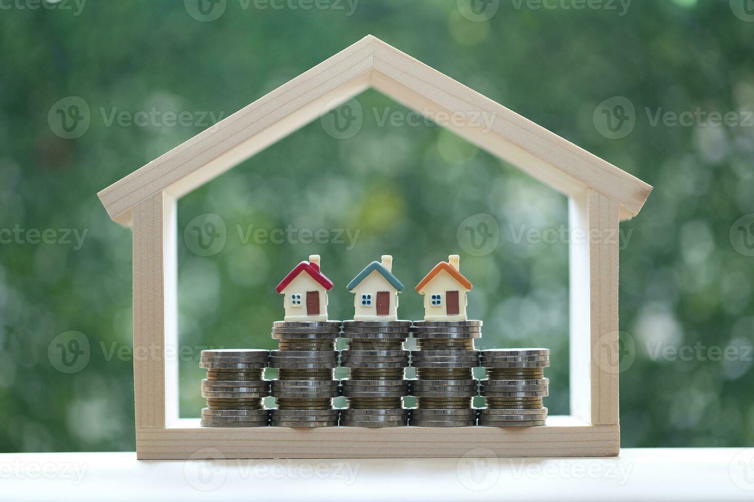 Small house in big house on natural green background, Business investment and real estate concept photo