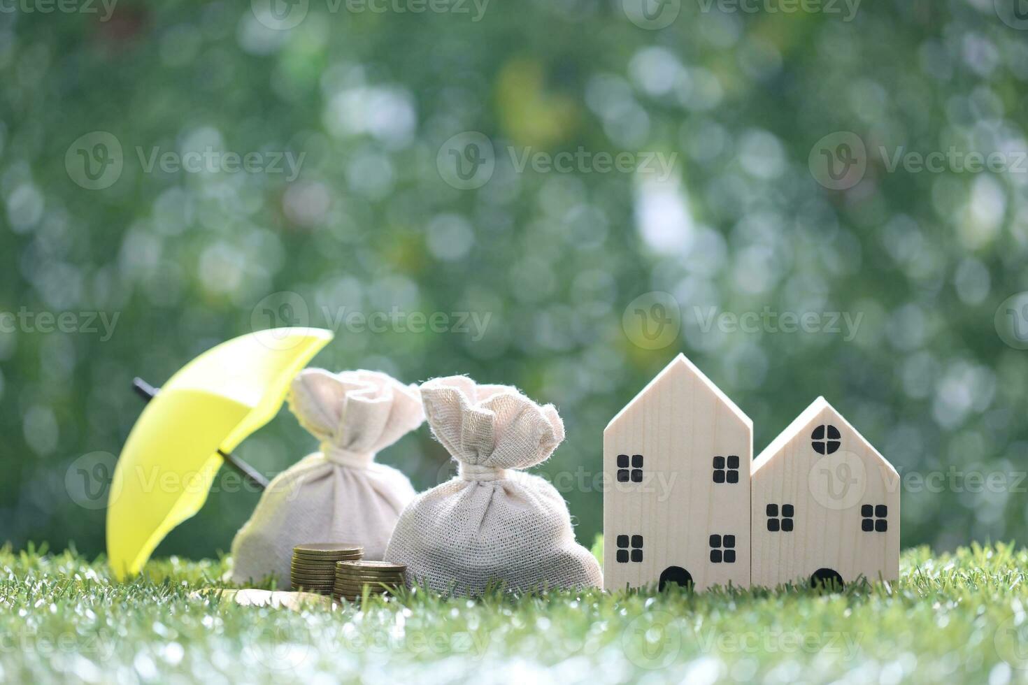 Finance, Model house and money bag on natural green background,Business investment and Save money for prepare in future concept photo