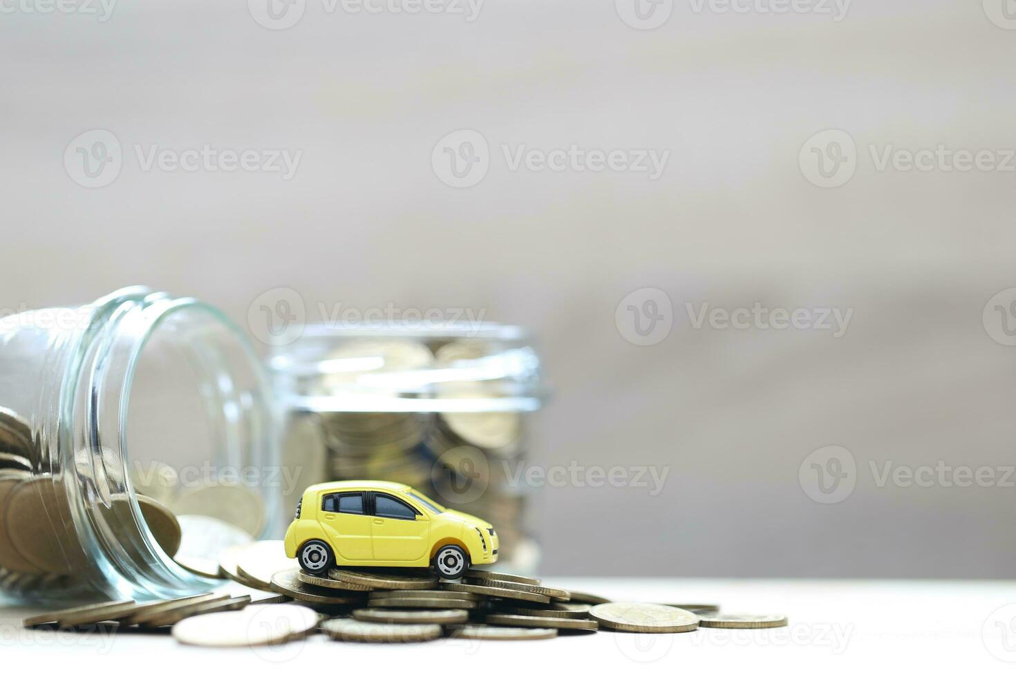 Miniature car model on growing stack of coins money on white background, Saving money for car, Finance and car loan, Investment and business concept photo