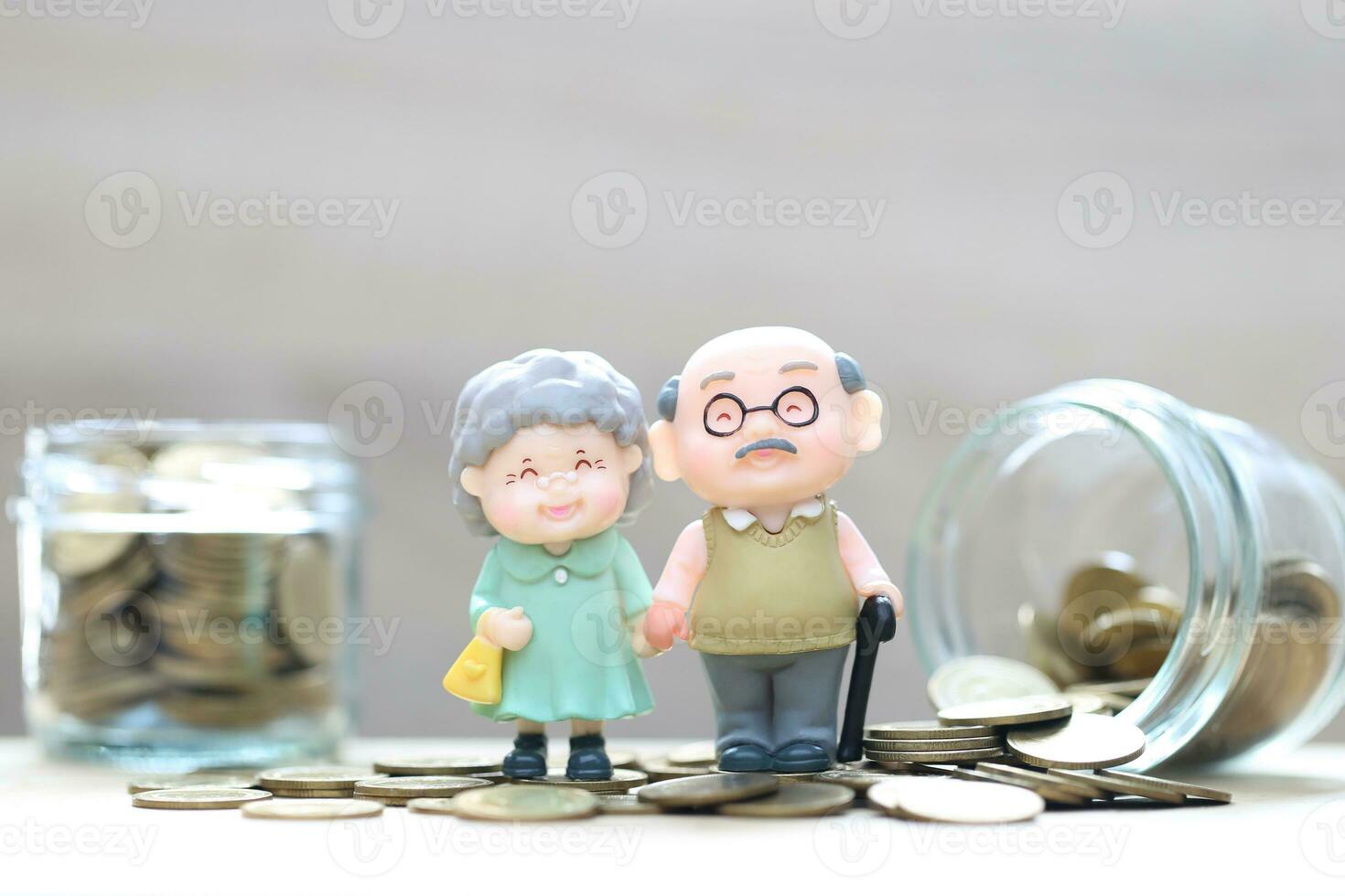Mutual fund,Love couple senior and gold coin money in the glass bottle on white background, Save money for prepare in future and pension retirement concept photo