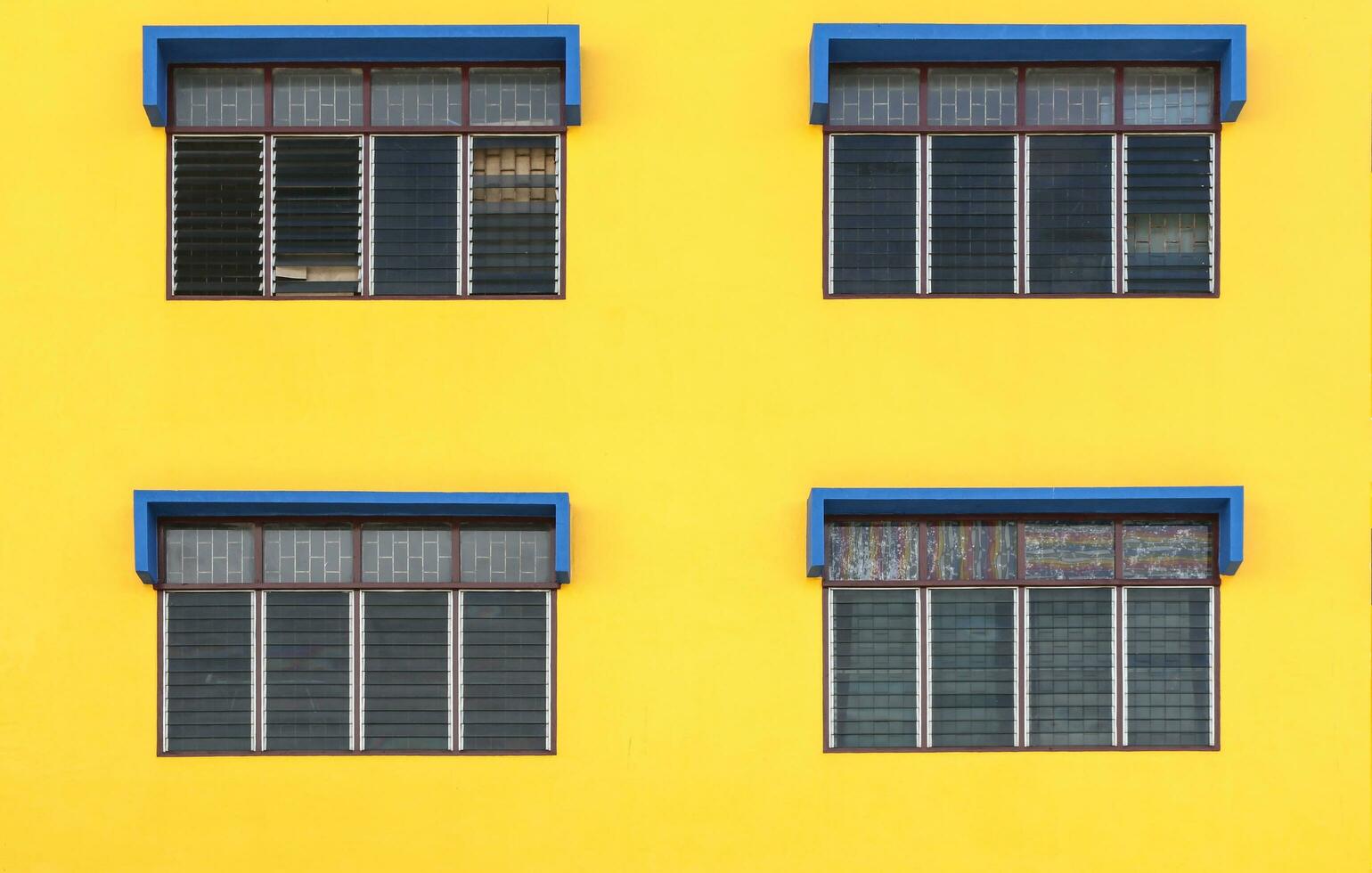 4 windows with a yellow background and painted blue windows photo