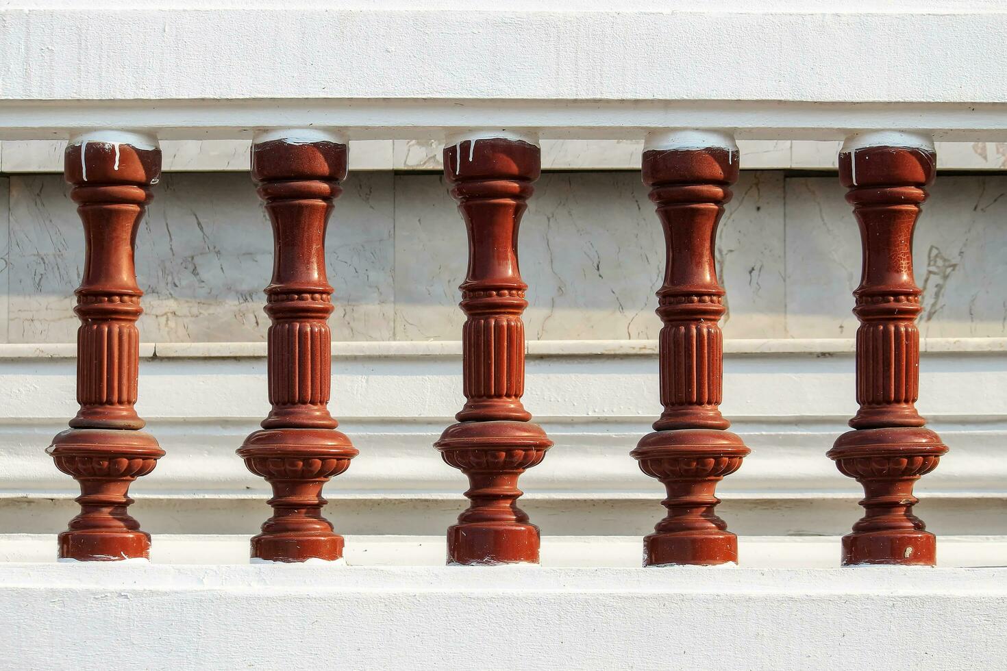 Brown stucco balustrade background wall is made up of marble slabs. photo