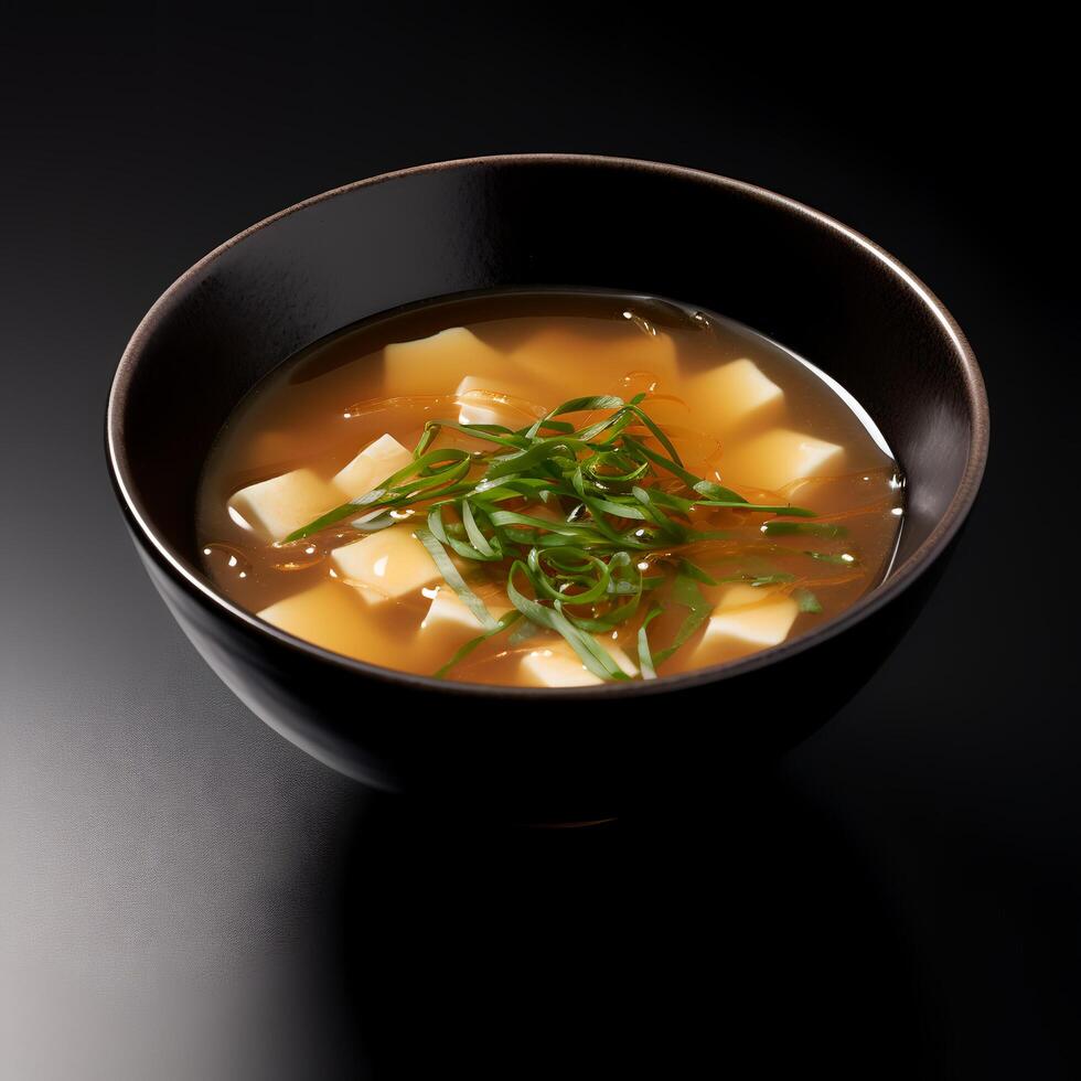 Food photography of Miso Soup on black bowl isolated on dark background. photo